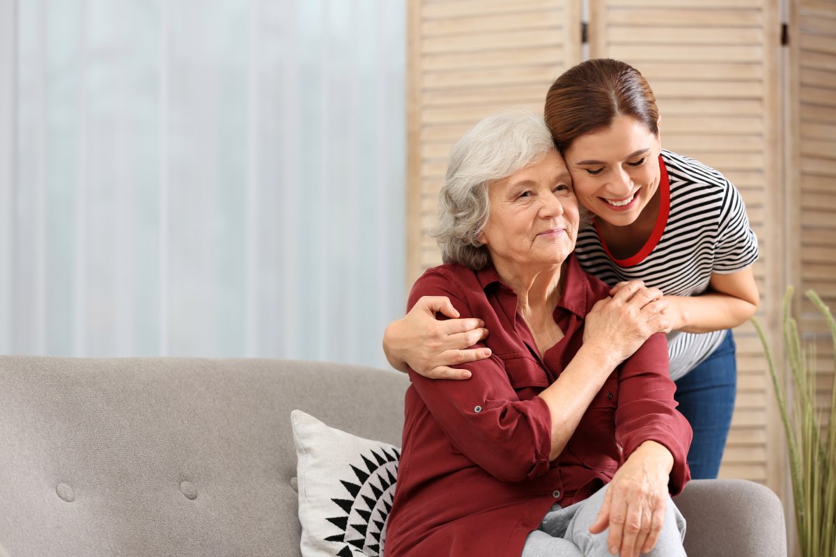 Senior woman embracing caregiver